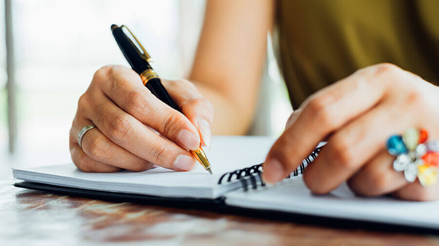 woman writing to-do list