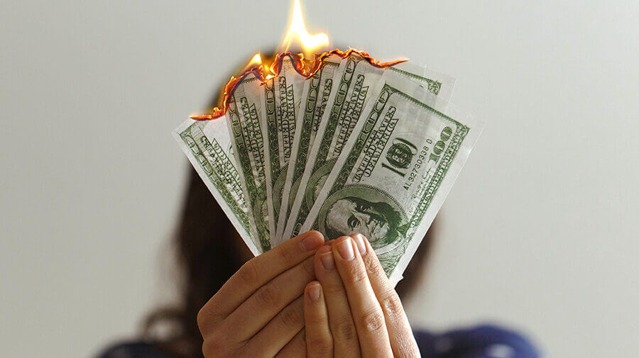 Woman holding burning money