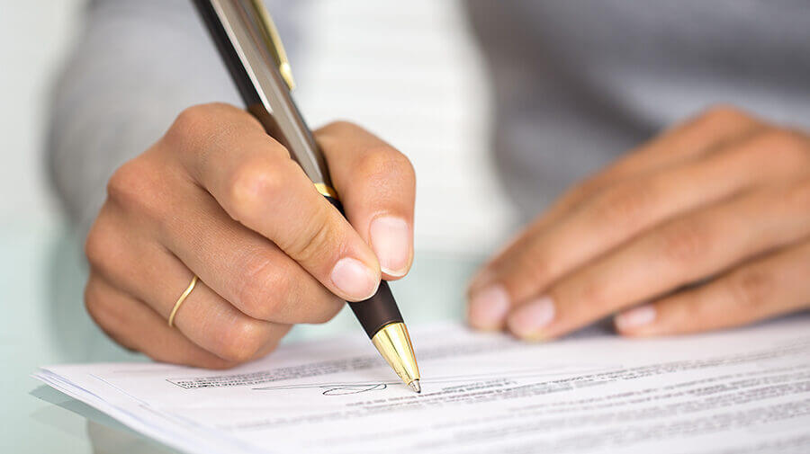 Woman signing a change order contract
