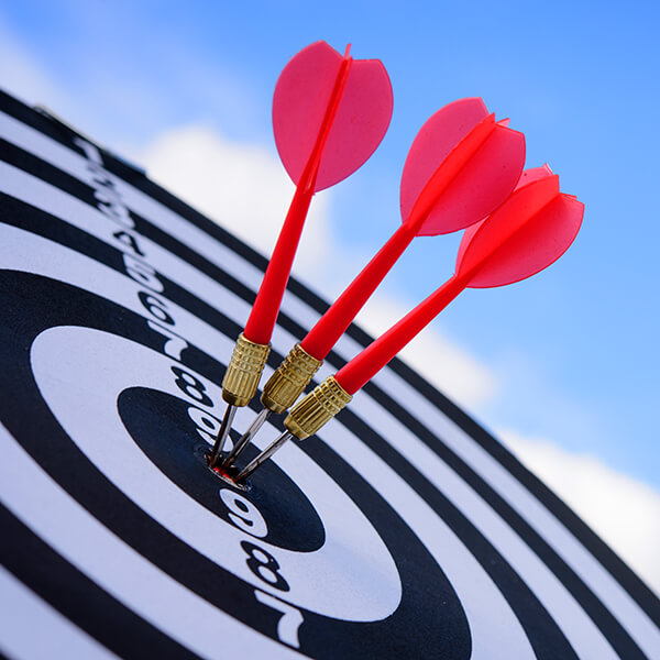 Three darts in the center of a bullseye to represent getting your brand messaging right for your ideal clients
