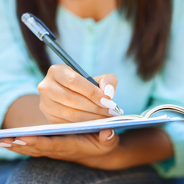 Woman writing in a workbook