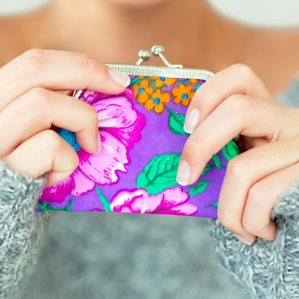 Woman holding a colorful coin purse full of content marketing results
