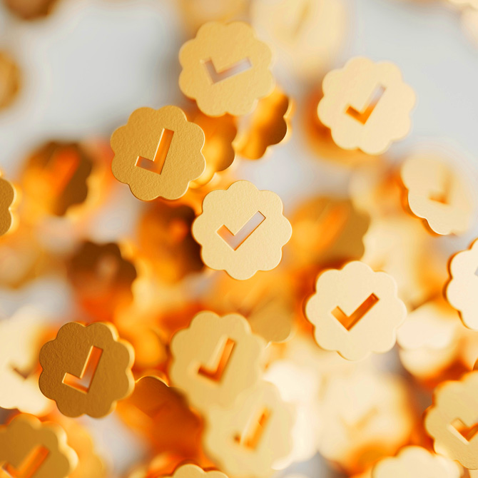 Lots of yellow, scalloped-edge discs with a check mark cutouts, each representing a check of confidence in a brand